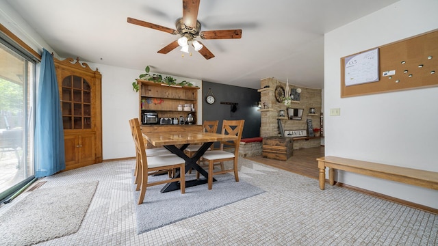 113 Maple Ave, Mount Morris, IL 61054 - dining space featuring ceiling fan, light carpet, baseboards, and a fireplace