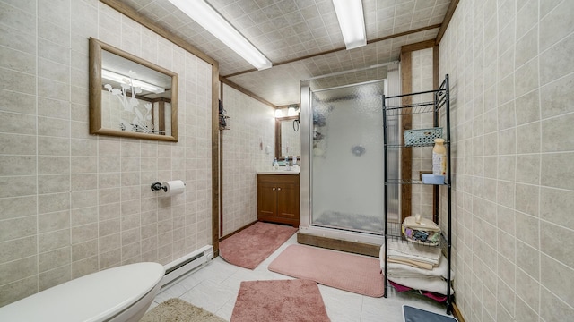 113 Maple Ave, Mount Morris, IL 61054 - bathroom with baseboard heating, tile walls, a stall shower, vanity, and toilet