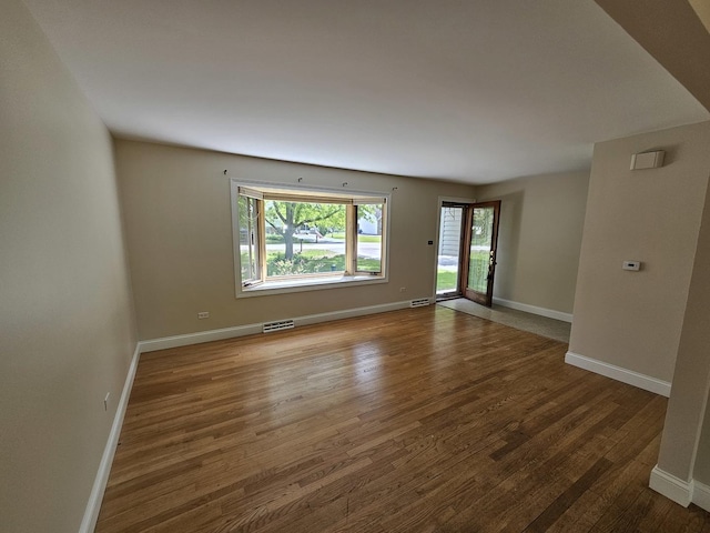 5S426 Columbia St, Naperville, IL 60563 - empty room with plenty of natural light, wood finished floors, and baseboards