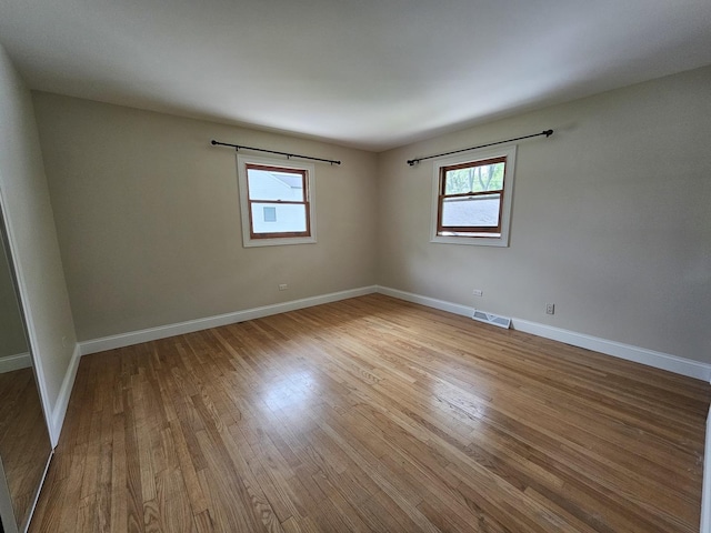 5S426 Columbia St, Naperville, IL 60563 - empty room with plenty of natural light, wood finished floors, and baseboards