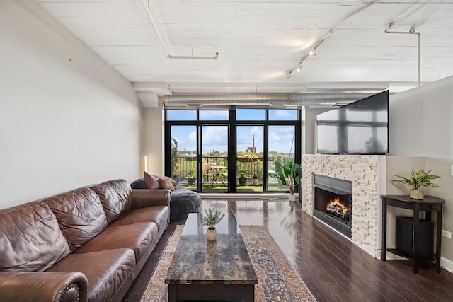 1524 S Sangamon St Unit 512, Chicago, IL 60608 - living area featuring rail lighting, hardwood / wood-style floors, and a stone fireplace