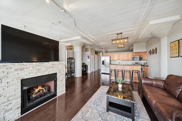 1524 S Sangamon St Unit 512, Chicago, IL 60608 - living room with dark wood-type flooring, rail lighting, and a stone fireplace