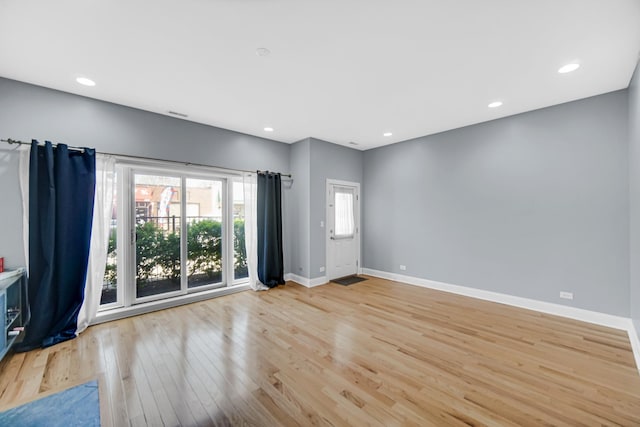 3436 N Harlem Ave Unit 1, Chicago, IL 60634 - spare room with wood finished floors, baseboards, and recessed lighting