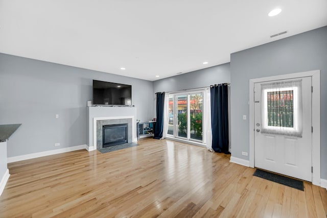 3436 N Harlem Ave Unit 1, Chicago, IL 60634 - unfurnished living room featuring light wood-style flooring, a high end fireplace, baseboards, and recessed lighting