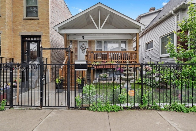 5642 W Dakin St, Chicago, IL 60634 - view of front of property featuring brick siding, a fenced front yard, a porch, and a gate