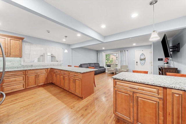 5642 W Dakin St, Chicago, IL 60634 - kitchen featuring light wood-type flooring, a peninsula, open floor plan, brown cabinetry, and recessed lighting