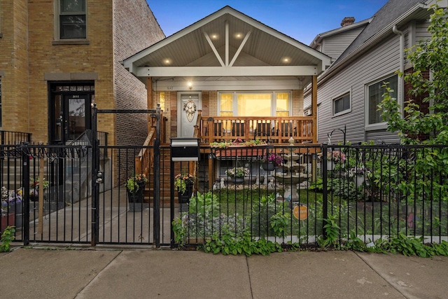 5642 W Dakin St, Chicago, IL 60634 - view of front of property featuring brick siding, covered porch, a fenced front yard, and a gate