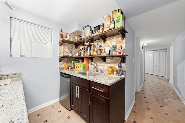 5642 W Dakin St, Chicago, IL 60634 - indoor wet bar featuring dishwashing machine, baseboards, decorative backsplash, and light tile patterned floors