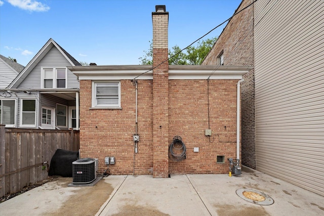 5642 W Dakin St, Chicago, IL 60634 - view of side of property featuring brick siding, a chimney, a patio area, and central air condition unit