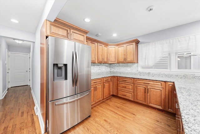 5642 W Dakin St, Chicago, IL 60634 - kitchen with stainless steel fridge with ice dispenser, light wood-style flooring, backsplash, light stone countertops, and recessed lighting