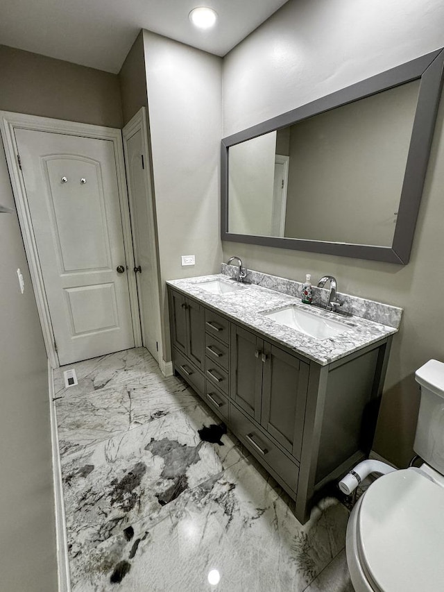 8210 Elmwood Ave Unit 106, Skokie, IL 60077 - bathroom featuring marble finish floors, double vanity, and toilet