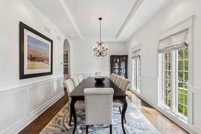 16 Tuttle Ave, Clarendon Hills, IL 60514 - dining area featuring healthy amount of natural light, a tray ceiling, wood finished floors, arched walkways, and a wainscoted wall