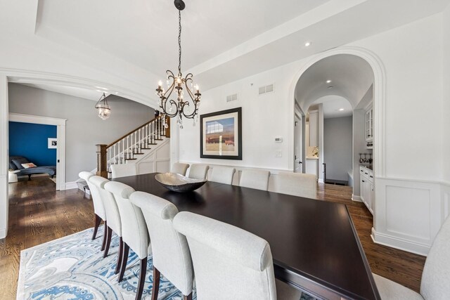 16 Tuttle Ave, Clarendon Hills, IL 60514 - dining space with stairs, a chandelier, dark wood finished floors, arched walkways, and recessed lighting