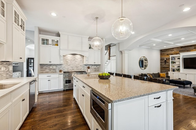 16 Tuttle Ave, Clarendon Hills, IL 60514 - kitchen featuring stainless steel appliances, arched walkways, open floor plan, tasteful backsplash, and recessed lighting