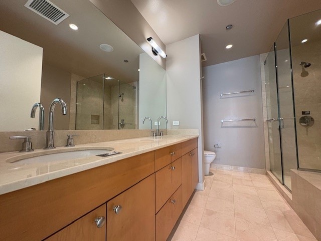 270 E Pearson St Unit 602, Chicago, IL 60611 - bathroom featuring double vanity, a stall shower, toilet, tile patterned floors, and recessed lighting