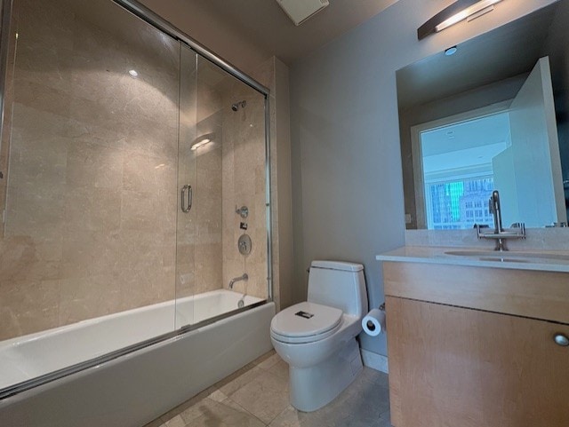 270 E Pearson St Unit 602, Chicago, IL 60611 - bathroom featuring toilet, vanity, bath / shower combo with glass door, and tile patterned floors