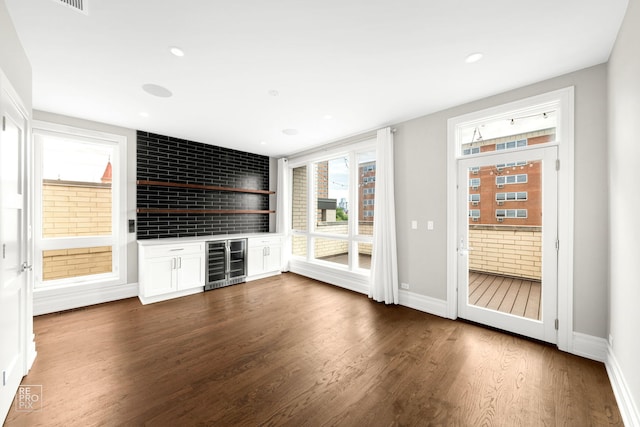 1448 W Chestnut St Unit 3, Chicago, IL 60642 - unfurnished living room featuring beverage cooler, a dry bar, dark wood-type flooring, baseboards, and recessed lighting