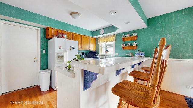 1719 Westbridge Ct, Hoffman Estates, IL 60194 - kitchen featuring light wood-style flooring, tile counters, a kitchen breakfast bar, open shelves, and a peninsula