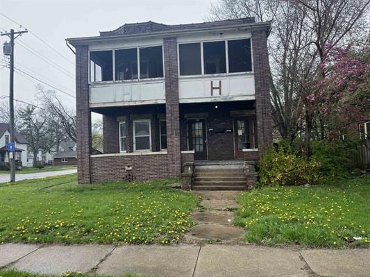 1825 S 6th St, Rockford, IL 61104 - view of front facade featuring a front yard and brick siding