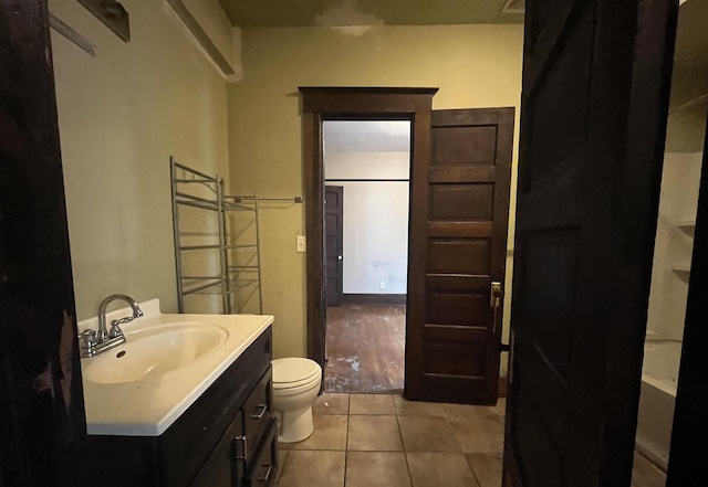 1825 S 6th St, Rockford, IL 61104 - full bathroom with toilet, vanity, and tile patterned floors