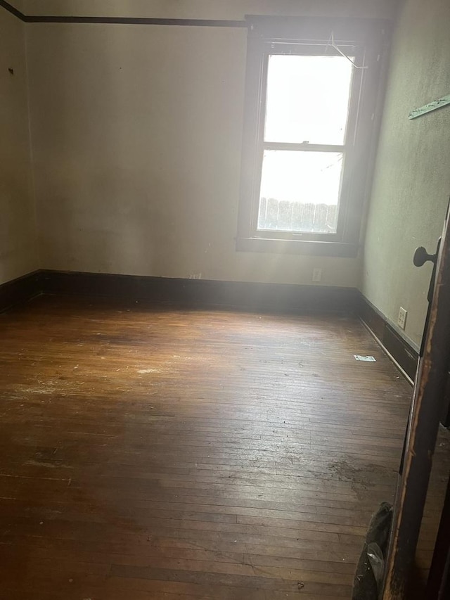 1825 S 6th St, Rockford, IL 61104 - empty room with dark wood finished floors and baseboards
