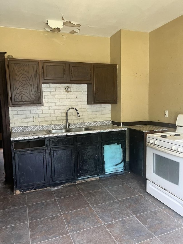 1825 S 6th St, Rockford, IL 61104 - kitchen with white range, a sink, dark brown cabinets, and light countertops