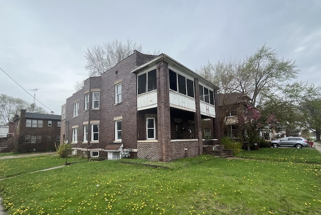 1825 S 6th St, Rockford, IL 61104 - view of side of home featuring a yard and brick siding