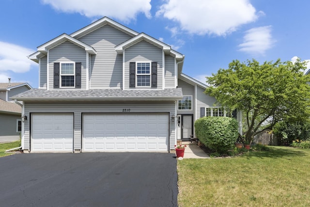 2210 Falcon Dr, Plainfield, IL 60586 - view of front facade featuring a garage, driveway, and a front lawn