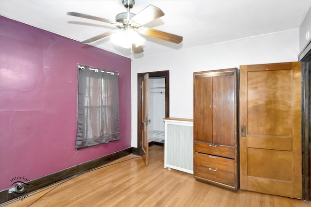 136 E 10th St, Chicago Heights, IL 60411 - unfurnished bedroom with light wood finished floors, ceiling fan, and baseboards