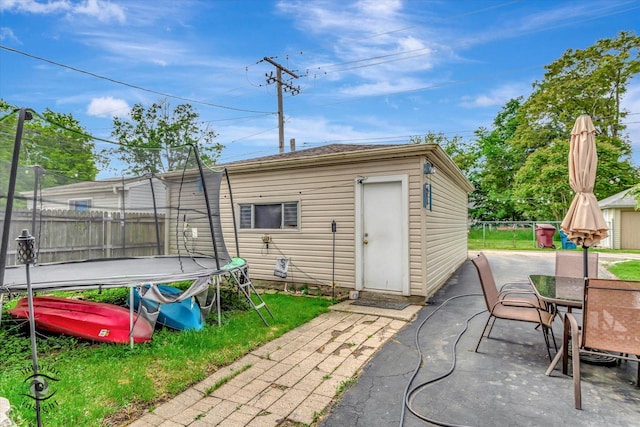 136 E 10th St, Chicago Heights, IL 60411 - view of outbuilding featuring a trampoline and outdoor dining space