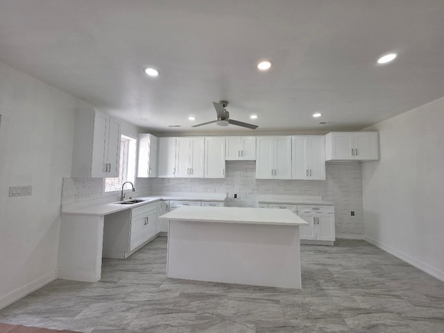 2906 W 40th St, Chicago, IL 60632 - kitchen with a kitchen island, baseboards, tasteful backsplash, white cabinets, and recessed lighting