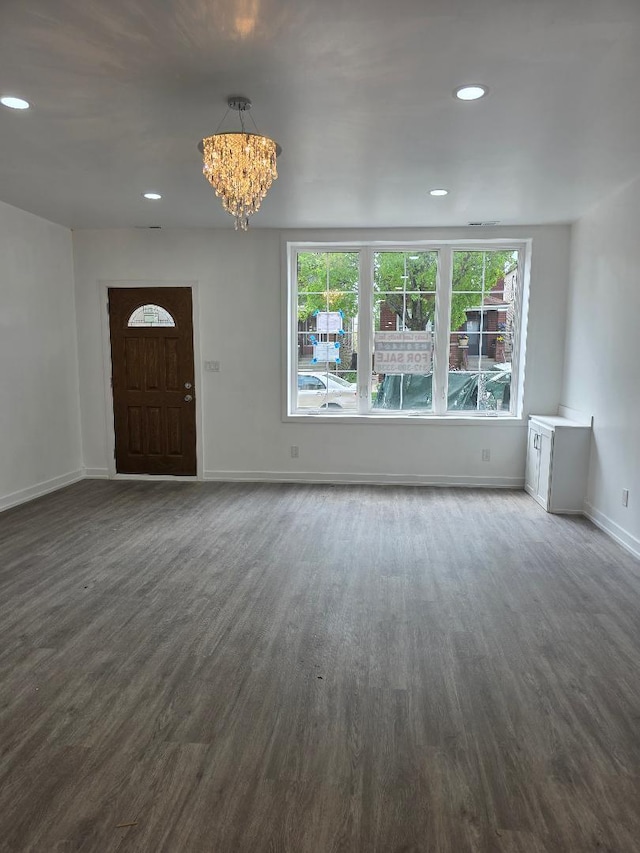 2906 W 40th St, Chicago, IL 60632 - unfurnished living room with a chandelier, dark wood-type flooring, baseboards, and recessed lighting