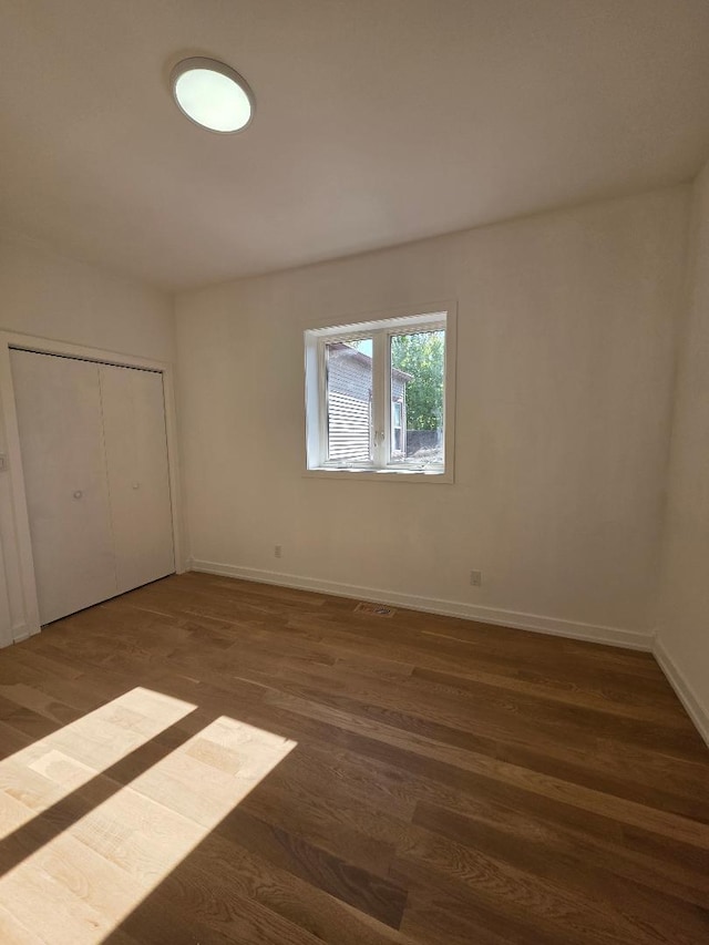 2906 W 40th St, Chicago, IL 60632 - unfurnished bedroom with wood finished floors, baseboards, and a closet