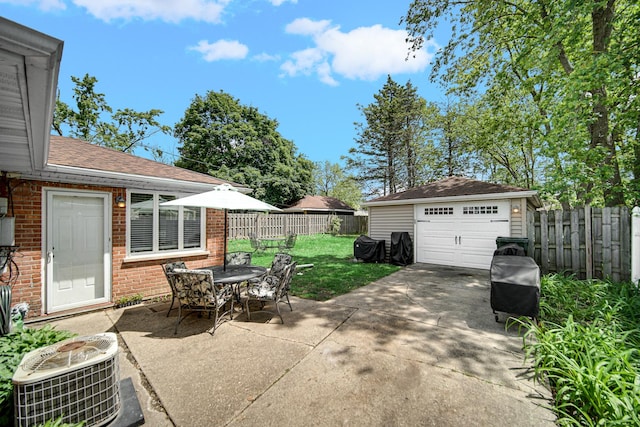 17601 Howe Ave, Homewood, IL 60430 - view of patio / terrace featuring a detached garage, central AC, an outdoor structure, driveway, and outdoor dining space