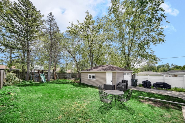 17601 Howe Ave, Homewood, IL 60430 - view of yard featuring a playground, an outdoor structure, and a patio area