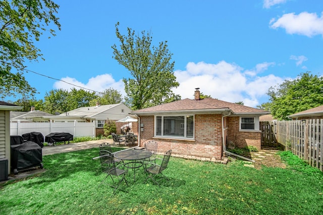 17601 Howe Ave, Homewood, IL 60430 - rear view of property featuring a chimney, brick siding, a patio area, and a shingled roof