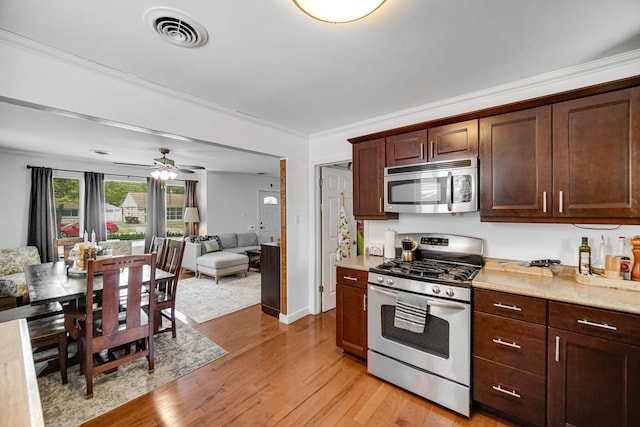 17601 Howe Ave, Homewood, IL 60430 - kitchen with appliances with stainless steel finishes, light wood-style flooring, light countertops, ceiling fan, and dark brown cabinets
