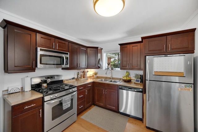 17601 Howe Ave, Homewood, IL 60430 - kitchen with stainless steel appliances, a sink, light wood-style flooring, light countertops, and crown molding