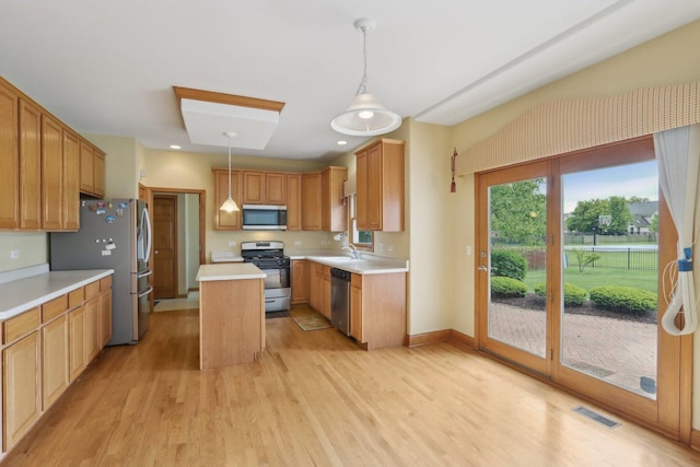 548 Asbury Dr, Aurora, IL 60502 - kitchen featuring stainless steel appliances, a sink, light wood finished floors, light countertops, and a center island