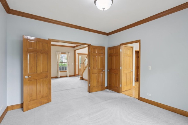 548 Asbury Dr, Aurora, IL 60502 - unfurnished room featuring crown molding, baseboards, and light carpet