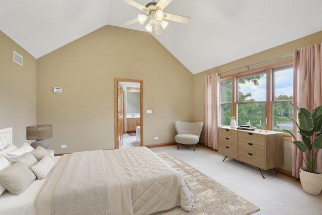 548 Asbury Dr, Aurora, IL 60502 - bedroom featuring lofted ceiling, light colored carpet, ensuite bathroom, ceiling fan, and baseboards