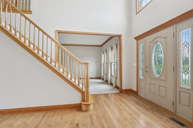 548 Asbury Dr, Aurora, IL 60502 - entrance foyer with healthy amount of natural light, baseboards, stairway, and a towering ceiling