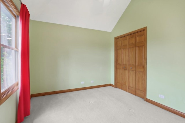548 Asbury Dr, Aurora, IL 60502 - unfurnished bedroom featuring vaulted ceiling, carpet, baseboards, and a closet