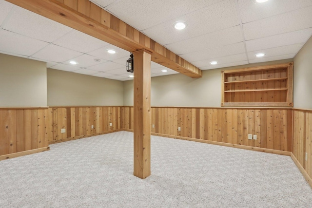 548 Asbury Dr, Aurora, IL 60502 - finished below grade area with a wainscoted wall, carpet flooring, a drop ceiling, wooden walls, and baseboards