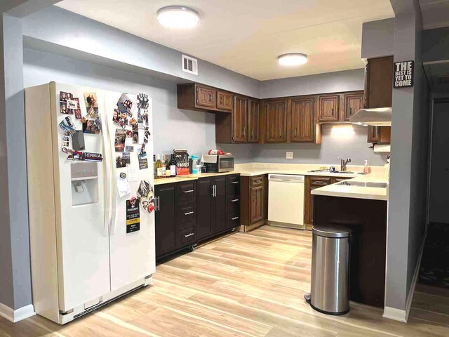 900 S River Rd Unit 3A, Des Plaines, IL 60016 - kitchen with white appliances, light wood-type flooring, light countertops, and dark brown cabinetry