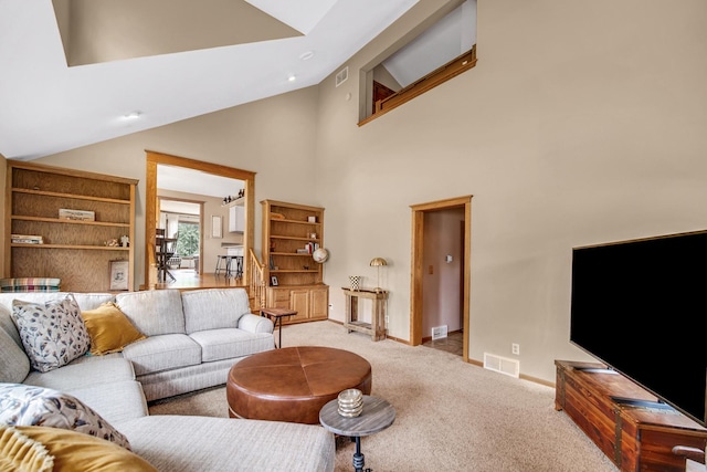1048 Somonauk St, Sycamore, IL 60178 - living room featuring light carpet, baseboards, and high vaulted ceiling