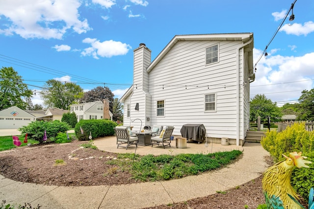 1048 Somonauk St, Sycamore, IL 60178 - back of property featuring a patio and a chimney