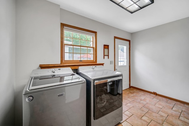 1048 Somonauk St, Sycamore, IL 60178 - laundry area featuring washing machine and dryer, light stone finish flooring, and baseboards