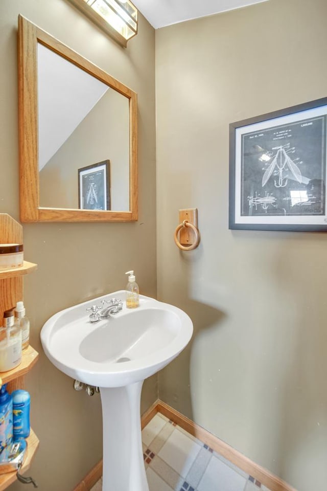 1048 Somonauk St, Sycamore, IL 60178 - bathroom featuring baseboards, a sink, and tile patterned floors