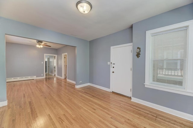 6834 S Rockwell St, Chicago, IL 60629 - empty room with baseboard heating, ceiling fan, light wood-style floors, and baseboards
